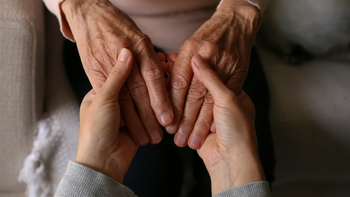 Older adults holding hands.