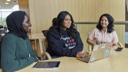 students sitting together at a table talking