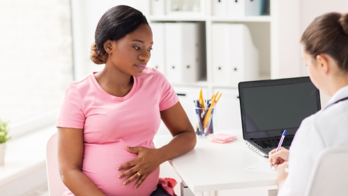 Pregnant person at doctor's office.