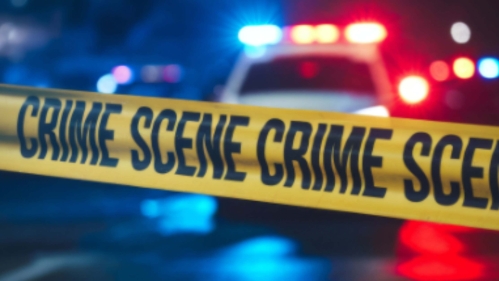 crime scene tape in front of police car