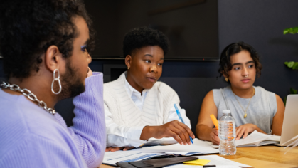 Three people sitting in a meeting talking.