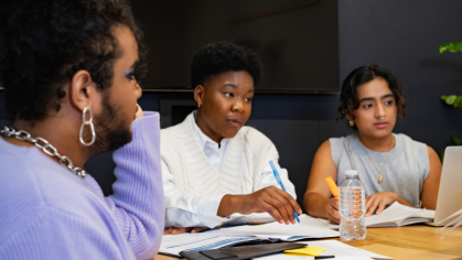 Three people sitting in a meeting talking. 