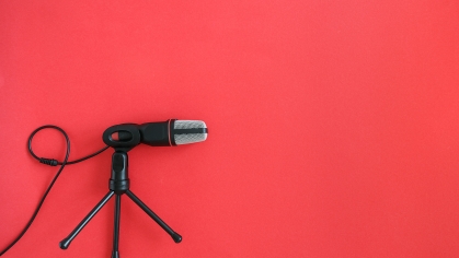 Microphone on red background.
