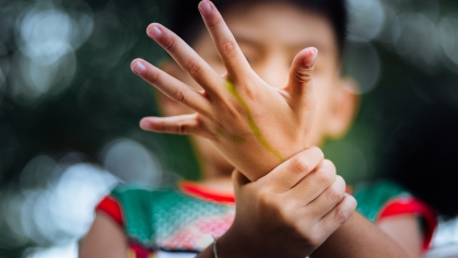 Child holding hand.