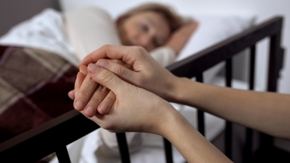 Person holding another person's hand.