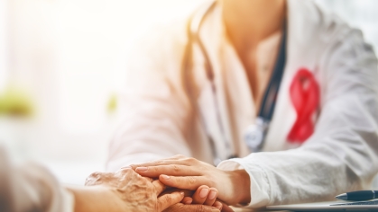 Doctor holding patient's hand.