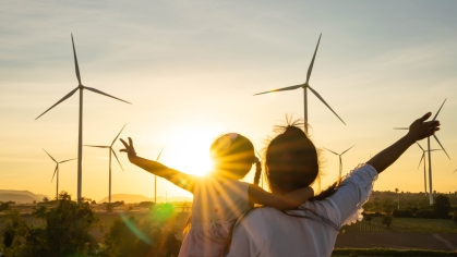 mom and daughter in front of sun