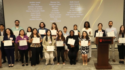 graduates inducted into delta omega posing for photo