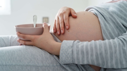 pregnant woman with a bowl of cereal