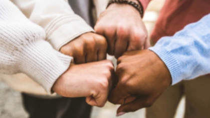 group of people joining hands