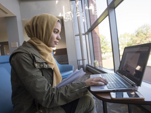 Student working on laptop.