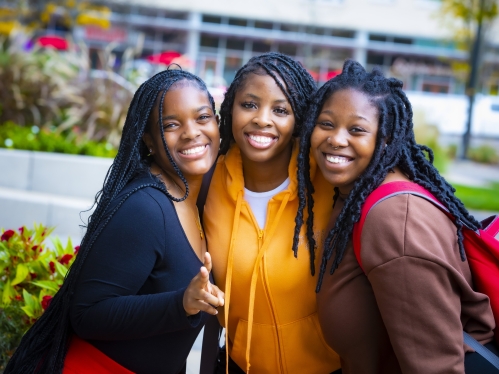 Three people looking at camera.