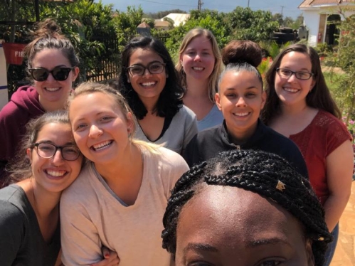 Selfie by 8 smiling students in Tanzania.