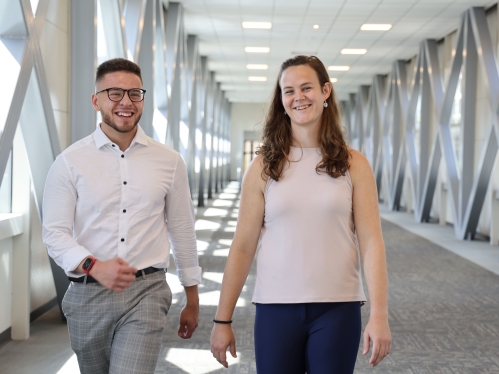 Two students walking and talking.