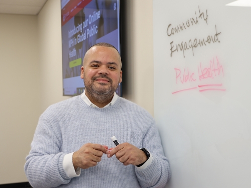 Professor standing in front of a whiteboard.