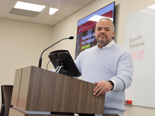 Professor standing in front of a whiteboard. 