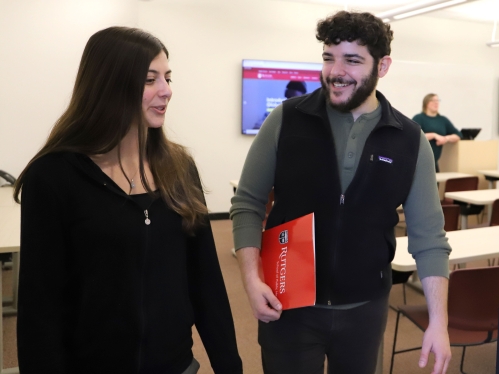 Two people exiting a classroom.