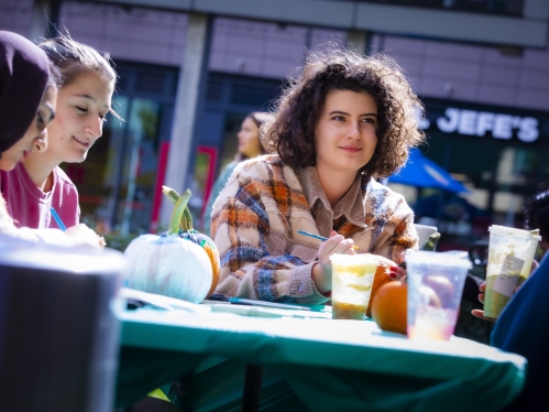 Students sitting at table and smiling.