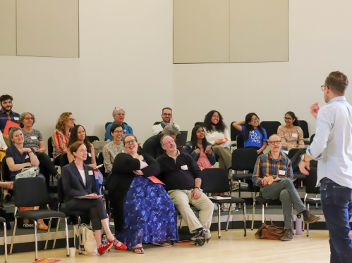 Group of people listening to lecture.