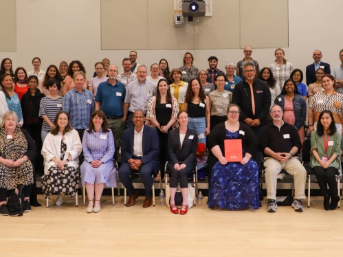 Large group of people posing for photo. 