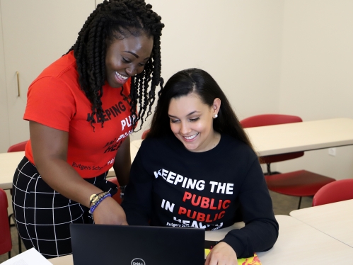 Students looking at a computer together