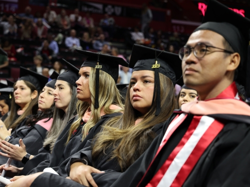 Grad. students sitting at ceremony.