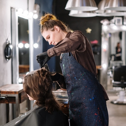 Barber cutting hair of a client.