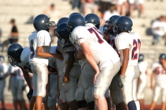 Football players in a huddle.