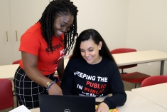 Students looking at a computer together