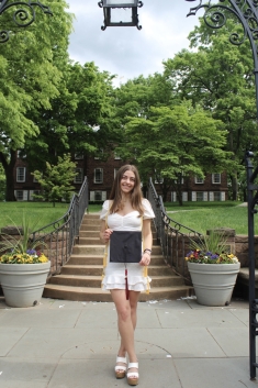 Student standing with graduation cap